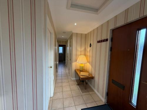 a hallway with a table with a lamp on it at The Airds Hotel and Restaurant in Port Appin