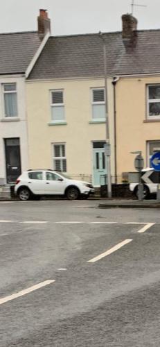 a white car parked on the side of a street at Lynne's Place in Carmarthen