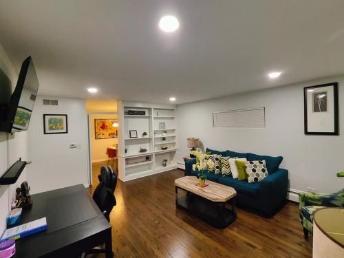 a living room with a blue couch and a table at Coloful - Cozy - 1-BR & Sofa-bed in Waukegan