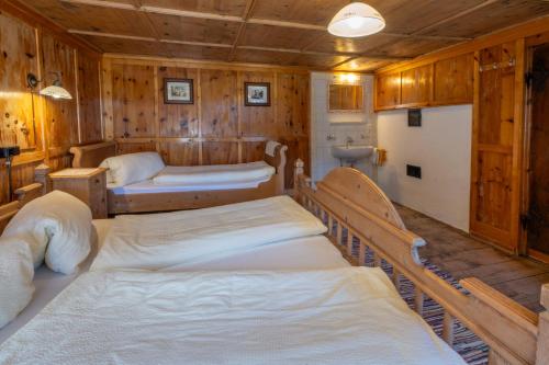 a room with three beds in a wooden room at Steffa Hamat in Ischgl