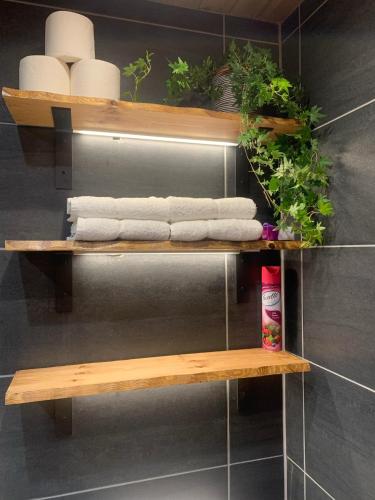 a wooden shelf with towels and plants on it at Glas Bheinn Cottage in Luib