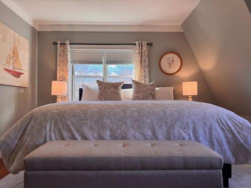 a bedroom with a large bed with a window at White Sails Inn in Kennebunk
