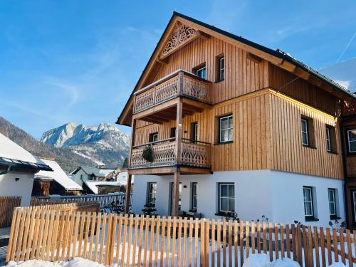 a large wooden house with a fence in front of it at Haus Christl&Franz in Bad Aussee