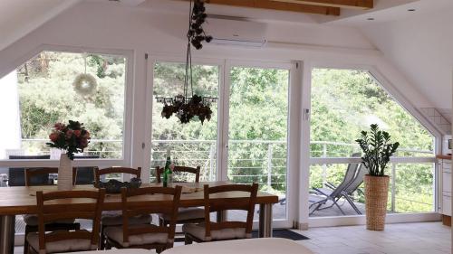 a dining room with a table and some windows at Ferienwohnung Bestensee in Bestensee