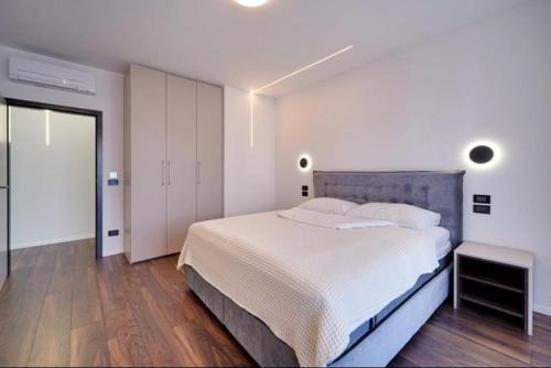 a bedroom with a large bed and a wooden floor at Villa Nico in Funtana