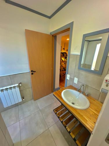 a bathroom with a sink and a mirror at Hostel TRUFA in San Carlos de Bariloche