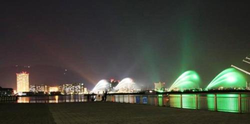 a view of a city at night with green lights at Guest House Hana in Otsu
