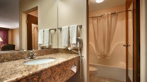 a bathroom with a sink and a shower at Super 8 by Wyndham McGehee in McGehee