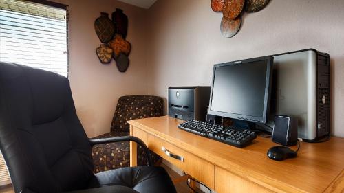 an office with a desk with a computer and a chair at Super 8 by Wyndham McGehee in McGehee