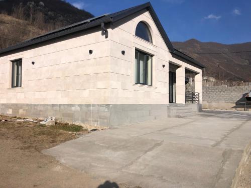 a large white building with windows on the side of it at L&vHOUSE in Dilijan