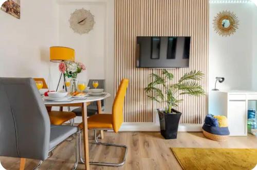 a dining room with a table and yellow chairs at 1 bed Flat ''Beta'' in Dewsbury road, Leeds in Hunslet