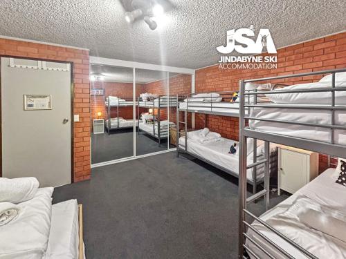 a room with a bunch of bunk beds at Sunrise 5 in Jindabyne