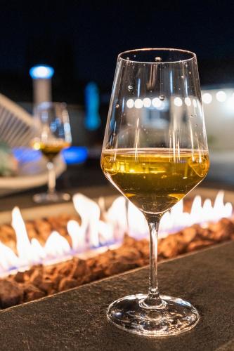 a glass of wine sitting on a table at Upscale Resort House, Views, Saltwater Pool, Spa in Spring Valley