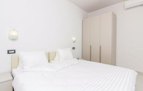 Ένα ή περισσότερα κρεβάτια σε δωμάτιο στο Funtana Appartements an der 1 Reihe vom Meer