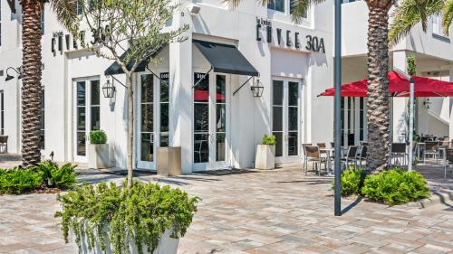 a courtyard with palm trees in front of a building at Monterey Condos C301 in Seacrest