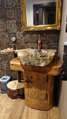 a bathroom with a wooden sink and a mirror at Casa Antón O Cebreiro in O Cebreiro
