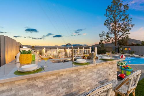 a patio with a table and chairs and a pool at Upscale Resort House, Views, Saltwater Pool, Spa in Spring Valley
