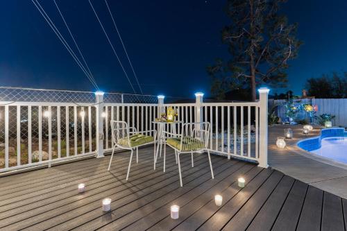 a deck with chairs and a table with lights on it at Upscale Resort House, Views, Saltwater Pool, Spa in Spring Valley