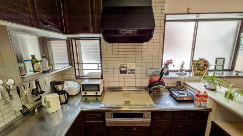 a kitchen with a sink and a counter top at 貸切民泊宿 だんねだんね Private guest house Danne-Danne in Ōno