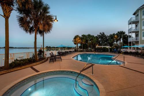 a swimming pool at a resort with a beach at The Waterfront Inn in The Villages