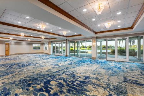 an empty ballroom with a large room with windows at The Waterfront Inn in The Villages