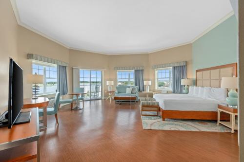a hotel room with a bed and a television at The Waterfront Inn in The Villages