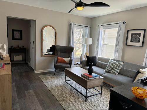 a living room with a couch and a chair at Wooster Square Gems in New Haven