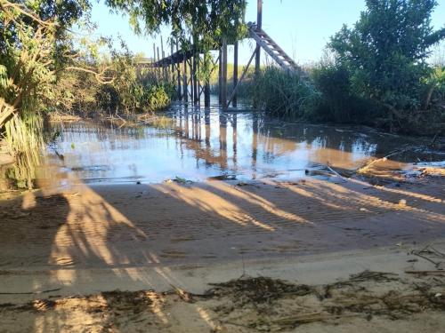 a body of water with a bridge in the background at La poderosa delta tigre in Tigre