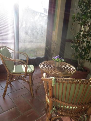 a patio with two chairs and a table and chairs at Casa Cecilia in Novellara