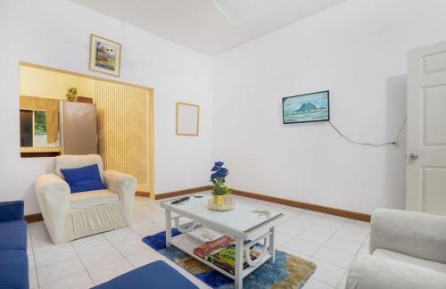a living room with a chair and a table at 876 Oasis in Content