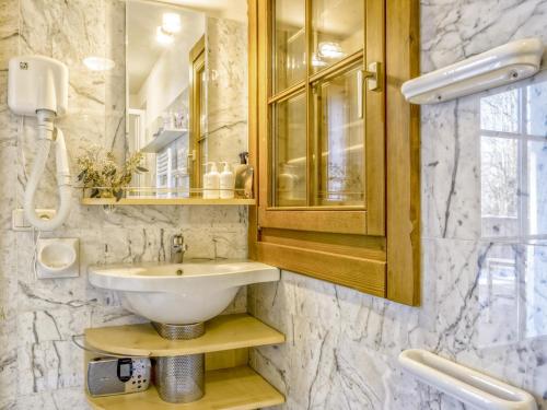 a bathroom with a sink and a mirror at Kitz Hills Chalet Mondschein in Kitzbühel