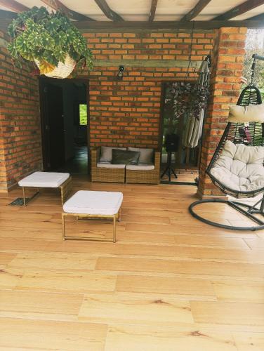 a room with two benches and a brick wall at Cabaña La Sanguina 4 Pax in Ocaña