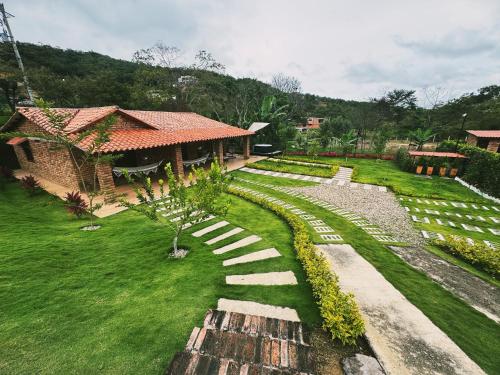 a garden with a stone path and a house at Cabaña La Sanguina 4 Pax in Ocaña