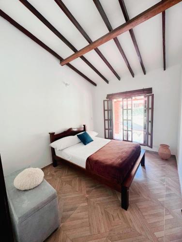 a bedroom with a large bed and a window at Cabaña La Sanguina 4 Pax in Ocaña