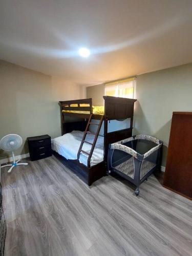 a bedroom with two bunk beds and a fan at depa del Oso in Nuevo Casas Grandes
