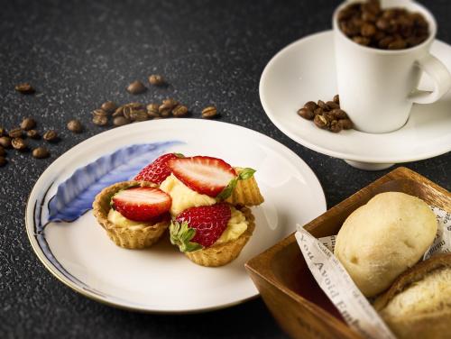 a plate with muffins with strawberries and a cup of coffee at Hana Irodori no Yado Kayuu in Taiji