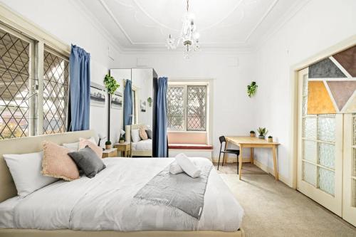 a bedroom with a large bed with blue curtains at Rustic Queen Room - Seconds to Stores & Eateries - Shared Bathroom in Sydney