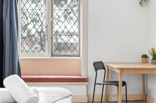 a room with a table and a window with a bench at Rustic Queen Room - Seconds to Stores & Eateries - Shared Bathroom in Sydney