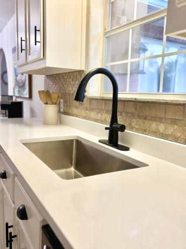 a kitchen sink with a black faucet at New! Close To Beach, Cozy, New beds & Family Friendly in Navarre