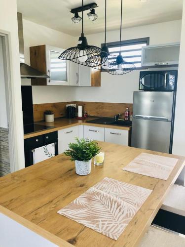 a kitchen with a wooden table with a potted plant on it at Appartement TERUPE in Papeete