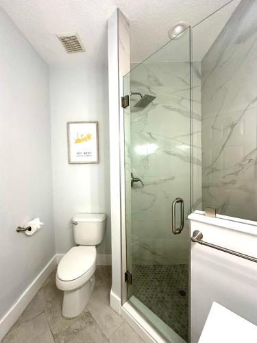 a bathroom with a toilet and a glass shower at Albatross Condo in PGA Village, 2 bedroom 1 bath, A Side in Carlton