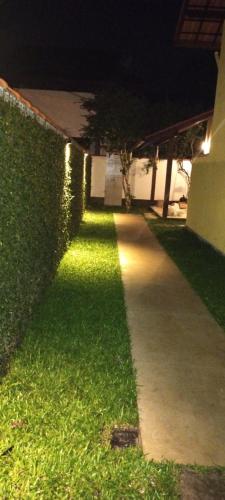 a walkway in front of a building at night at Casa da Pitanga Lumiar in Lumiar