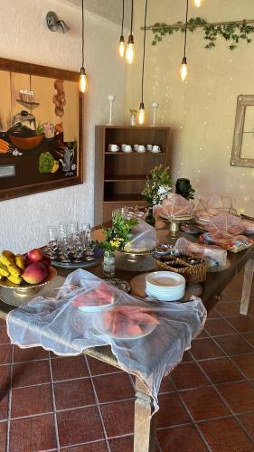 a table with food on it in a kitchen at Pousada Casa Mendes in Guapimirim