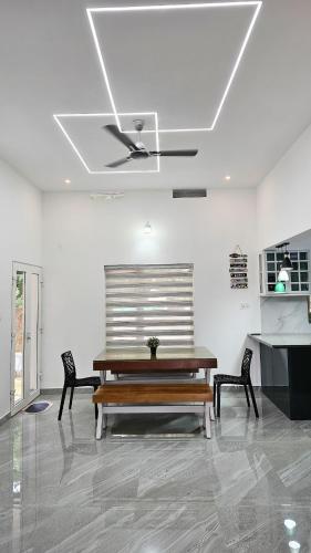 a living room with a bench and a ceiling at Uthuppan's 2 bedroom first floor in Ūdumbanshola