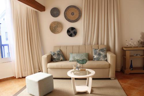 a living room with a couch and a table at Albatros by R&R 2 in Villas del Mar