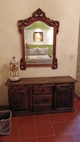 a mirror on top of a dresser in a room at Casa Limonchelo Hotel B&B in Morelia