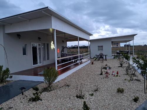 a small white house with a patio and a table at Agroktima in Arta
