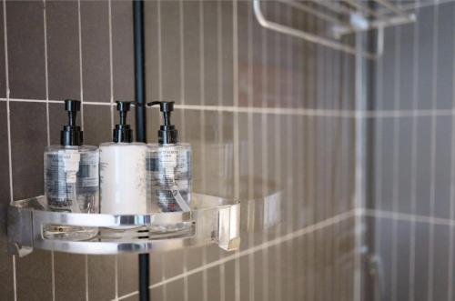 a soap dispenser in a shower in a bathroom at Echarm Hotel Chengdu Dujiangyan Scenic South Bridge in Chengdu