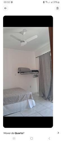 a picture of a bedroom with a bed and a window at Lar Suave Lar in Florianópolis
