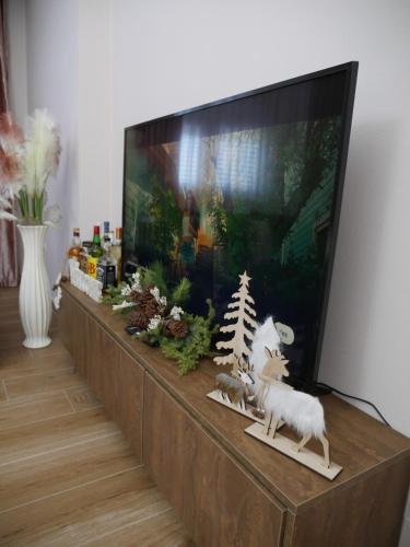 a flat screen tv sitting on top of a entertainment center at Golden view in Rrushkull